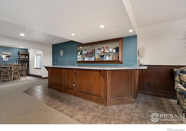 7225 Royal Country Down Dr, Windsor, CO 80550 - indoor wet bar featuring tile patterned flooring, recessed lighting, and carpet