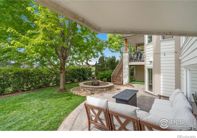 7225 Royal Country Down Dr, Windsor, CO 80550 - view of patio with stairway and an outdoor living space with a fire pit