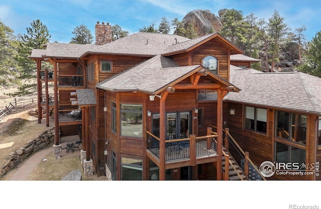 221 Twin Owls Ln Unit F-6, Estes Park, CO 80517 - rear view of house featuring roof with shingles and a chimney