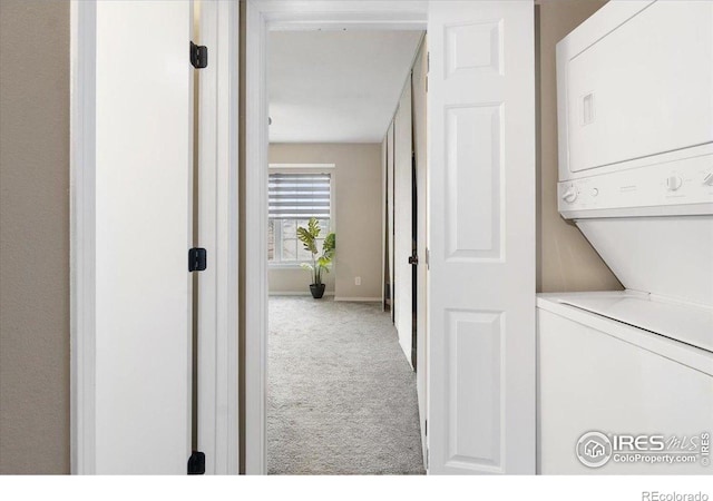 2660 E Otero Pl Unit 7, Centennial, CO 80122 - washroom featuring estacked washer and dryer, carpet, and baseboards