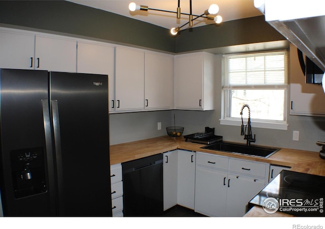 2660 E Otero Pl Unit 7, Centennial, CO 80122 - kitchen with black appliances, a sink, butcher block countertops, a chandelier, and white cabinetry