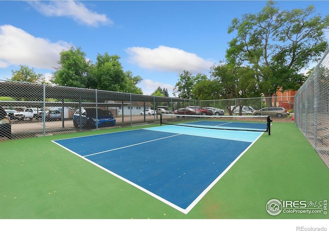 view of sport court featuring fence