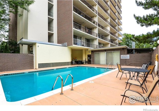 community pool with a patio area