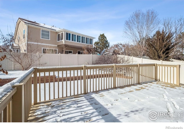 5036 Ridgewood Dr, Johnstown, CO 80534 - snow covered deck featuring a fenced backyard