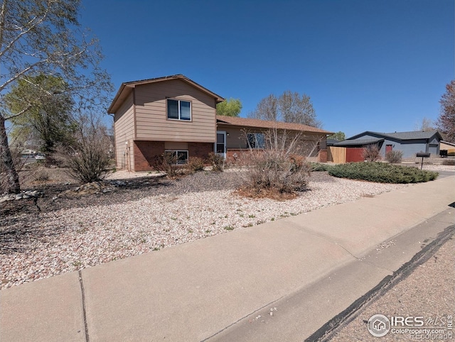 tri-level home with brick siding