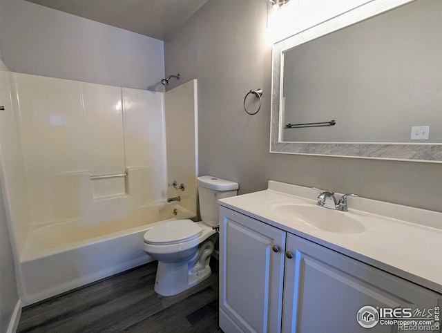 full bath featuring toilet, shower / washtub combination, vanity, and wood finished floors