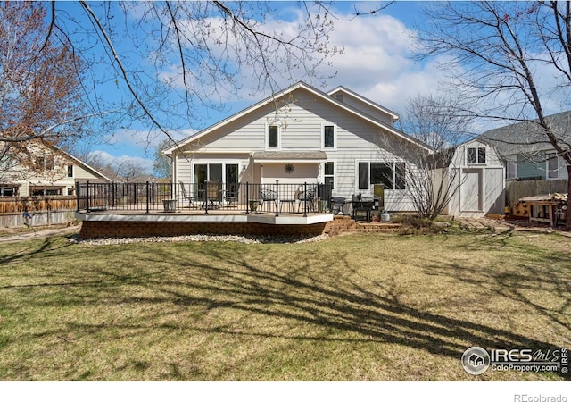 461 Scenic Dr, Loveland, CO 80537 - rear view of property featuring fence, a storage shed, a wooden deck, an outbuilding, and a yard