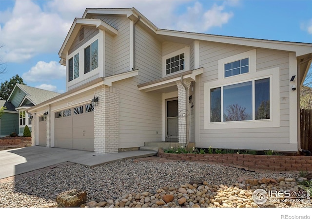 461 Scenic Dr, Loveland, CO 80537 - traditional-style house with brick siding, a garage, and concrete driveway