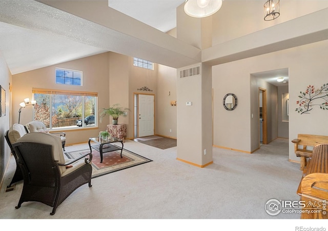 461 Scenic Dr, Loveland, CO 80537 - living room with high vaulted ceiling, baseboards, light carpet, and visible vents