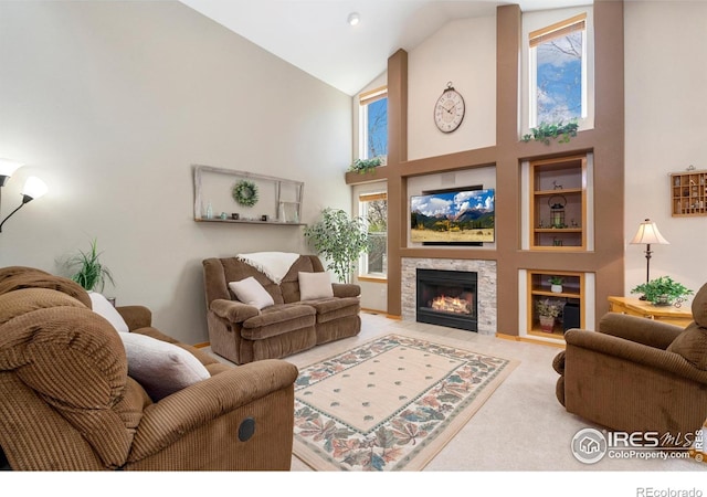 461 Scenic Dr, Loveland, CO 80537 - carpeted living room featuring a fireplace with flush hearth and high vaulted ceiling