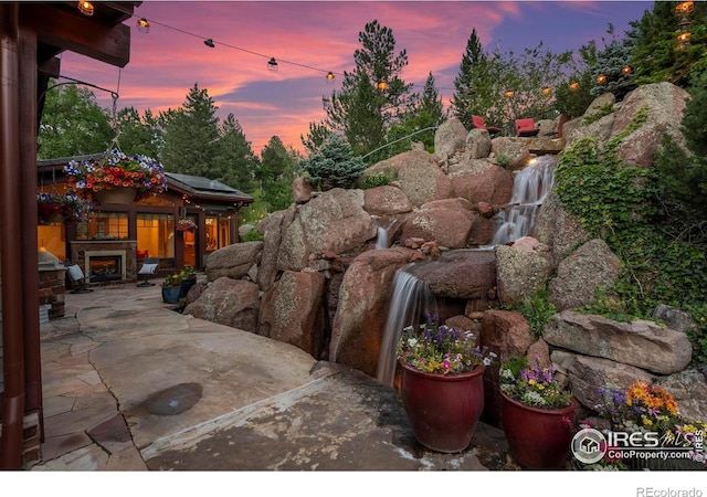 1420 Sierra Dr, Boulder, CO 80302 - patio terrace at dusk featuring exterior fireplace