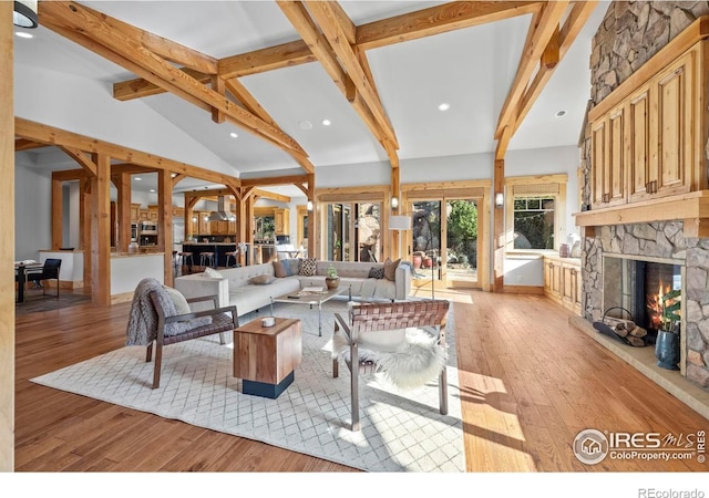 1420 Sierra Dr, Boulder, CO 80302 - living area featuring beam ceiling, a stone fireplace, light wood finished floors, and recessed lighting