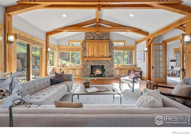 1420 Sierra Dr, Boulder, CO 80302 - living area featuring wood finished floors, lofted ceiling with beams, and a wealth of natural light