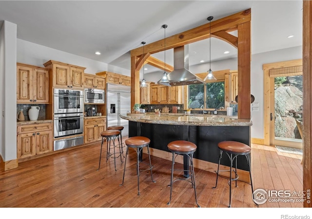 1420 Sierra Dr, Boulder, CO 80302 - kitchen featuring tasteful backsplash, a warming drawer, built in appliances, and island exhaust hood