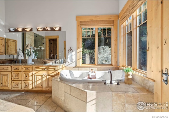 1420 Sierra Dr, Boulder, CO 80302 - bathroom featuring a bath, stone tile floors, double vanity, and a sink