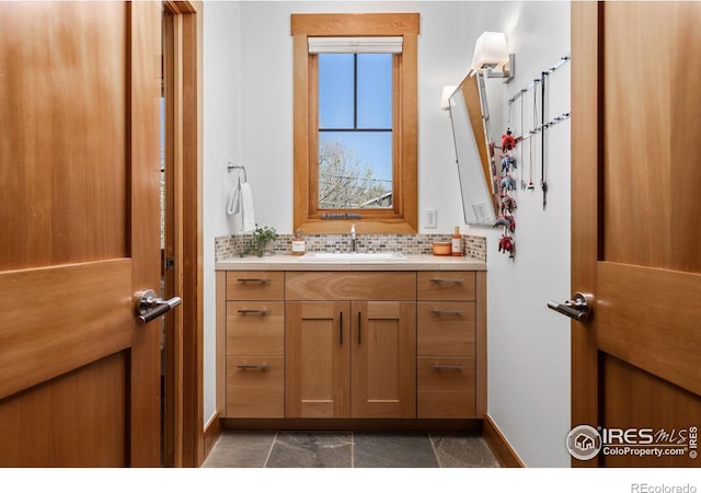bathroom featuring baseboards and vanity