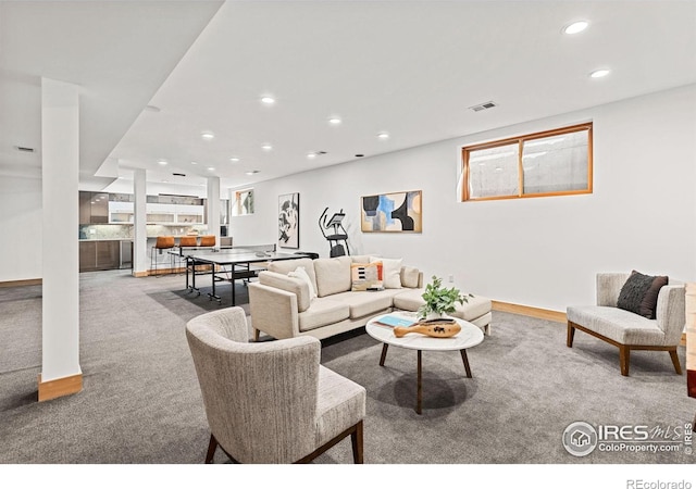 carpeted living area with visible vents and recessed lighting