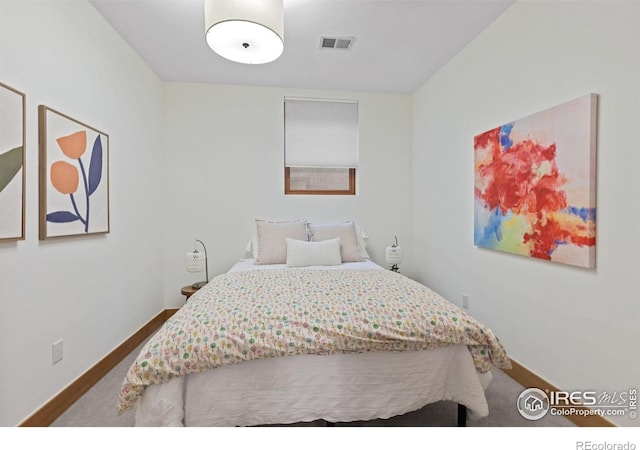 carpeted bedroom featuring visible vents and baseboards