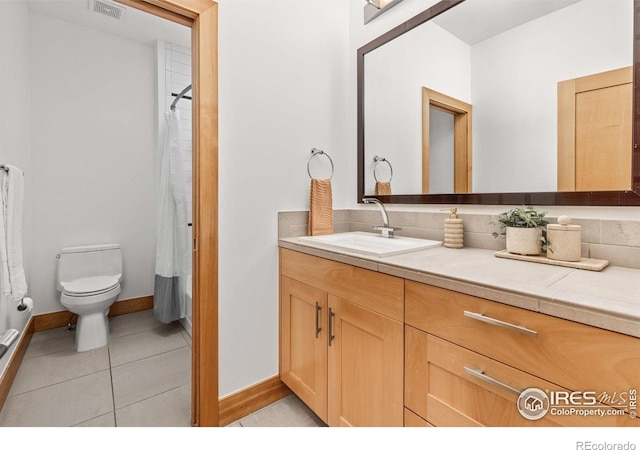 full bath with visible vents, tile patterned flooring, vanity, toilet, and baseboards