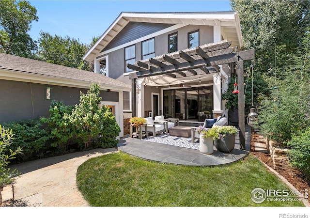 rear view of house with an outdoor living space, a patio area, stucco siding, and a pergola