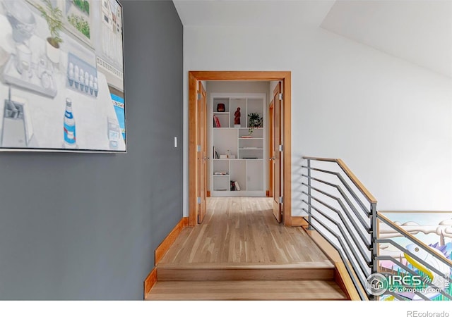 hallway featuring light wood-style floors and baseboards