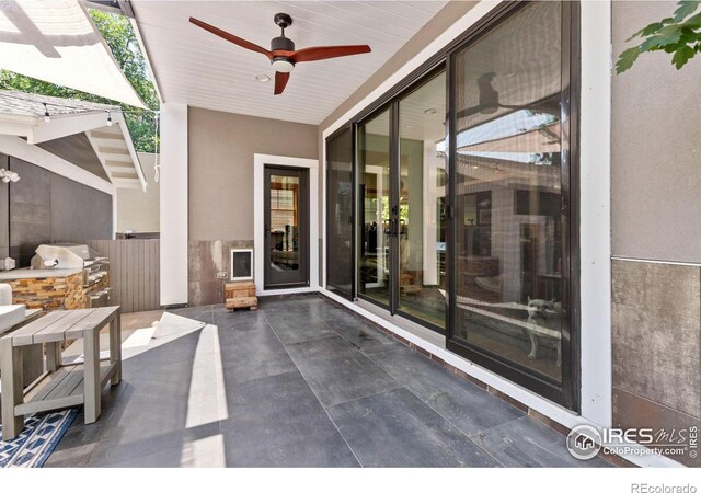 view of patio / terrace with ceiling fan, a grill, and area for grilling