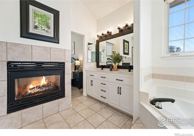 4939 Yoke Ct, Loveland, CO 80537 - full bath featuring a fireplace, tile patterned flooring, lofted ceiling, vanity, and tiled tub