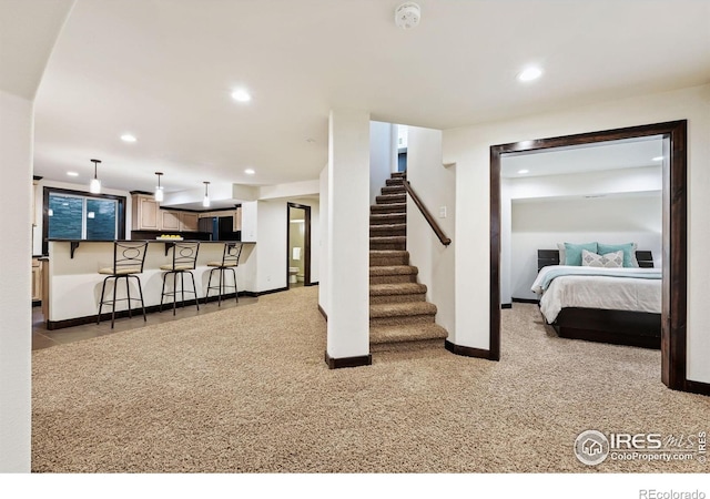 4939 Yoke Ct, Loveland, CO 80537 - carpeted living room featuring baseboards, recessed lighting, bar with sink, and stairs