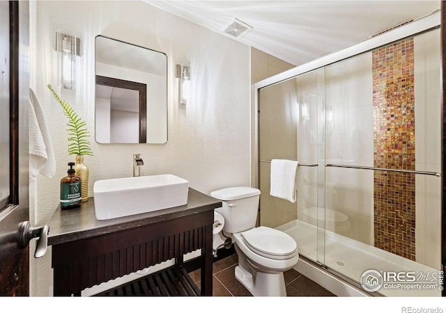 4939 Yoke Ct, Loveland, CO 80537 - bathroom with toilet, tile patterned flooring, a stall shower, and vanity