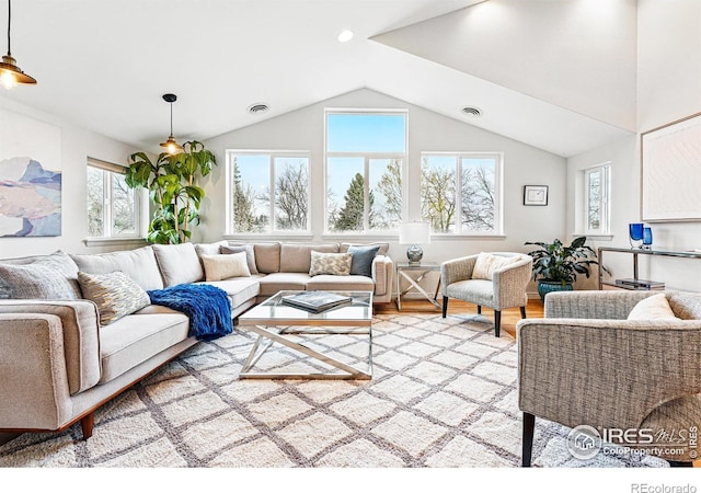 803 Ithaca Dr, Boulder, CO 80305 - living area with lofted ceiling, visible vents, light wood finished floors, and a wealth of natural light