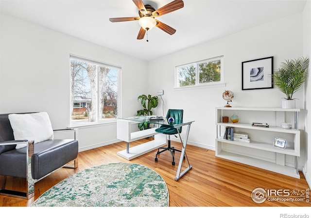 803 Ithaca Dr, Boulder, CO 80305 - home office featuring baseboards, a ceiling fan, and wood finished floors