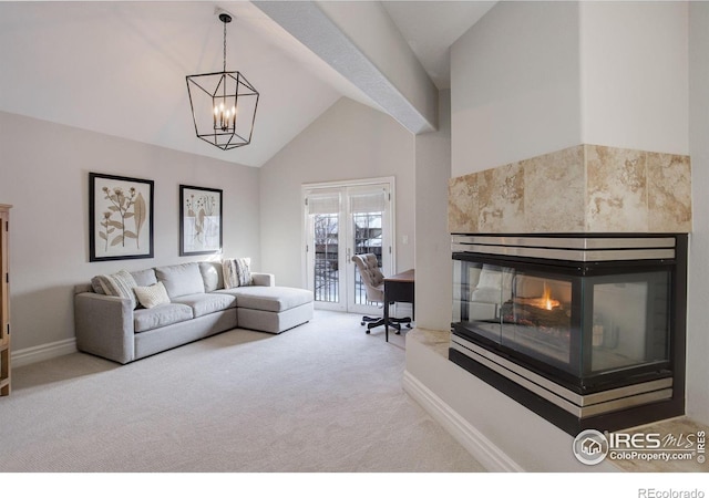 living area with carpet floors, baseboards, a multi sided fireplace, and an inviting chandelier