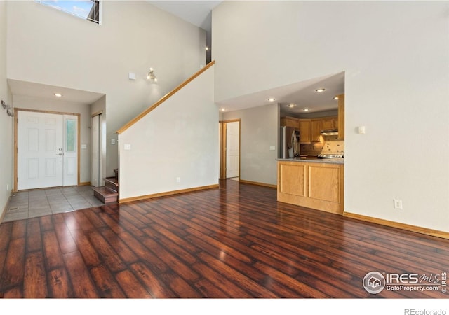 4603 Chokecherry Trl Unit 5, Fort Collins, CO 80526 - unfurnished living room featuring high vaulted ceiling, wood finished floors, stairway, and recessed lighting