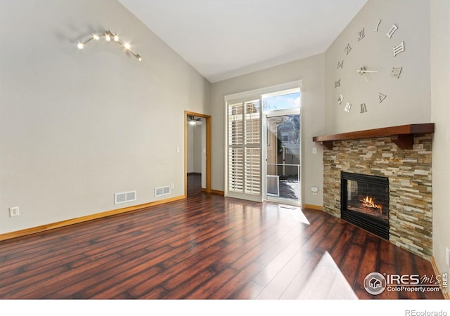 4603 Chokecherry Trl Unit 5, Fort Collins, CO 80526 - unfurnished living room featuring wood finished floors, vaulted ceiling, and a stone fireplace