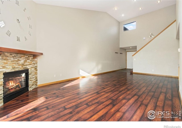 4603 Chokecherry Trl Unit 5, Fort Collins, CO 80526 - unfurnished living room featuring high vaulted ceiling, wood finished floors, a stone fireplace, and recessed lighting