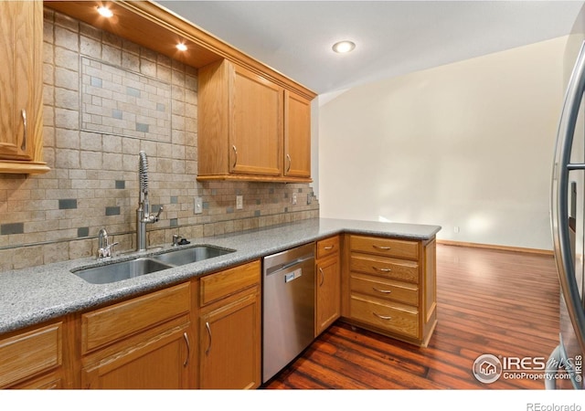 4603 Chokecherry Trl Unit 5, Fort Collins, CO 80526 - kitchen featuring tasteful backsplash, appliances with stainless steel finishes, a peninsula, dark wood-type flooring, and brown cabinets