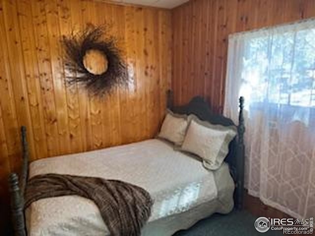 bedroom with wood walls