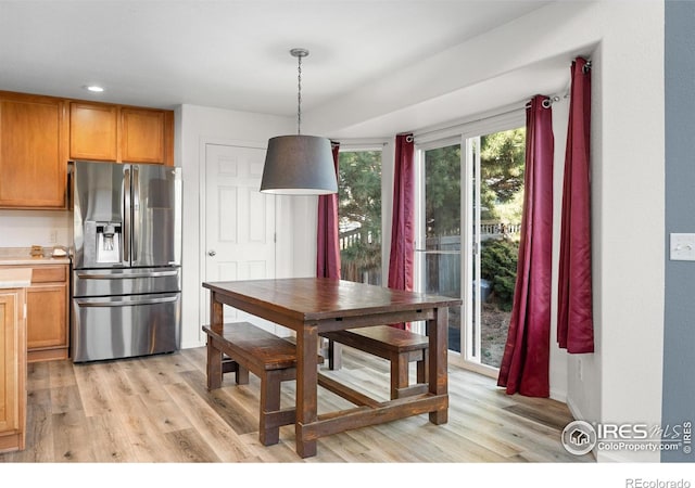 dining space with light wood-style floors and recessed lighting