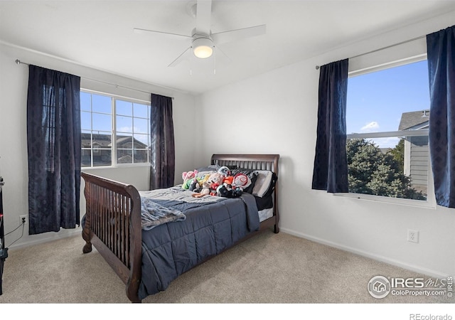 carpeted bedroom with baseboards and a ceiling fan