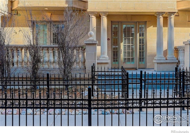 exterior space with fence and stone siding