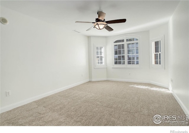 empty room featuring ceiling fan, baseboards, and carpet floors