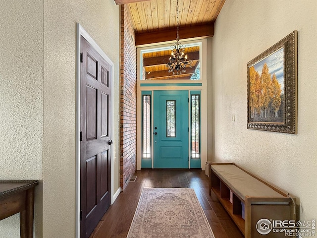 entryway featuring wooden ceiling, a textured wall, a notable chandelier, and wood finished floors