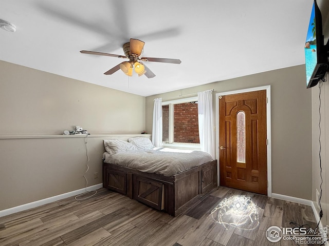 bedroom with ceiling fan, baseboards, and wood finished floors