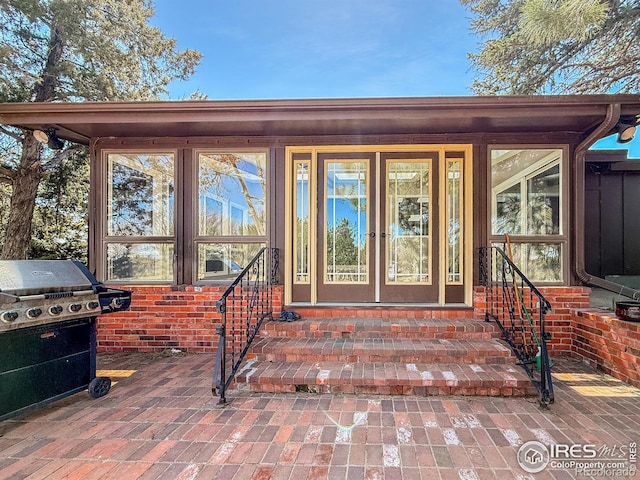 view of exterior entry with brick siding