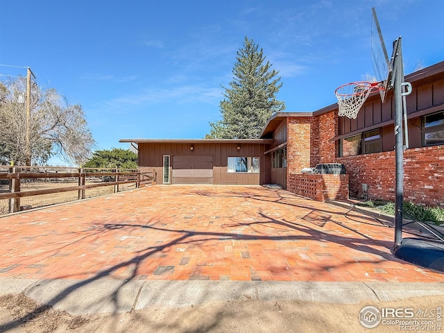view of front of home with brick siding and fence