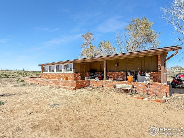 rear view of house with brick siding