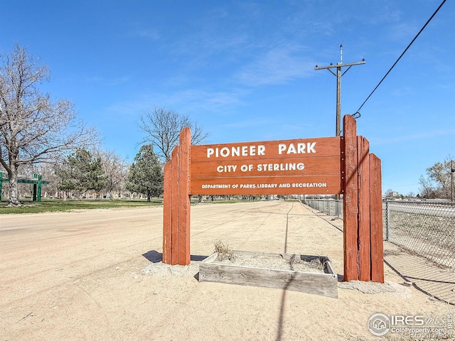 community sign featuring fence
