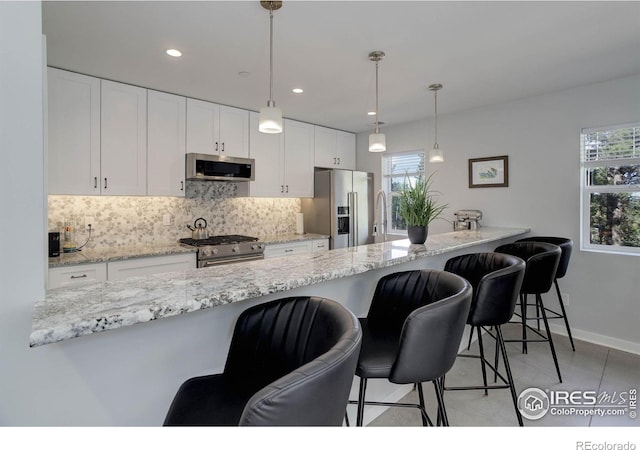 609 Hummer Dr, Nederland, CO 80466 - kitchen featuring white cabinetry, baseboards, backsplash, and stainless steel appliances