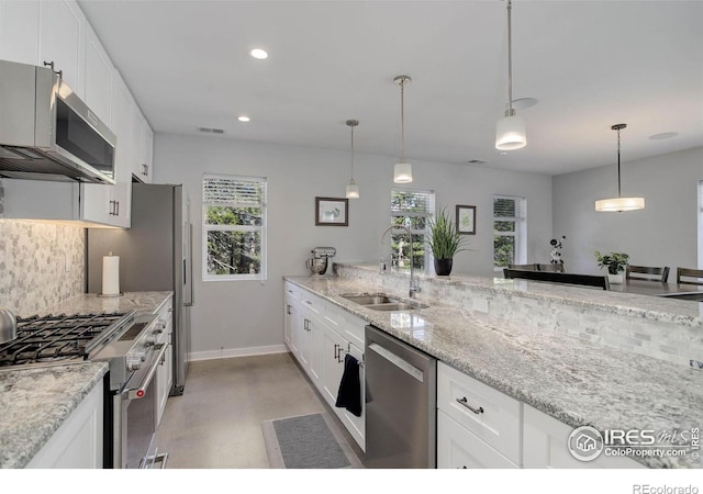 609 Hummer Dr, Nederland, CO 80466 - kitchen with baseboards, recessed lighting, white cabinetry, appliances with stainless steel finishes, and a sink
