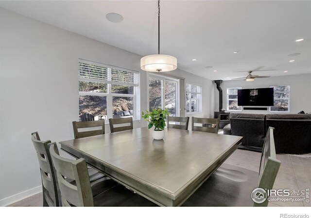 609 Hummer Dr, Nederland, CO 80466 - dining space featuring a wood stove, a ceiling fan, recessed lighting, and baseboards